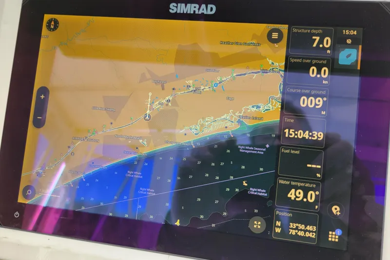 Slide: The Image of Simrad marine GPS display on 1979 Bertram 38 Convertible, showing navigation and environmental data. - 68