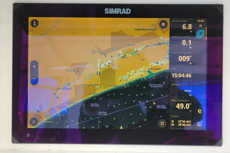 Slide: The Image of Simrad navigation display on a 1979 Bertram 38 Convertible boat, showing coastal map and data. - 69
