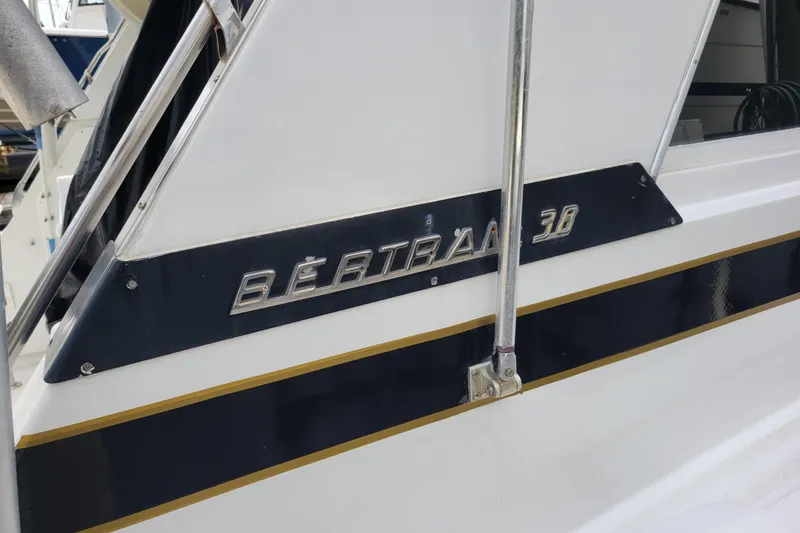 Slide: The Image of 1979 Bertram 38 Convertible boat with chrome lettering and sleek design. - 7