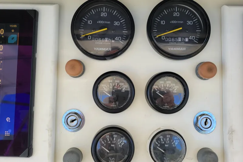 Slide: The Image of Instrument panel of a 1979 Bertram 38 Convertible boat with Yanmar gauges. - 70