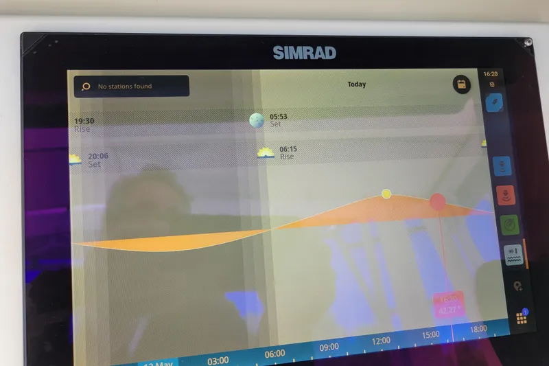 Slide: The Image of Simrad marine display showing tide and sun data on a 1979 Bertram 38 Convertible. - 71
