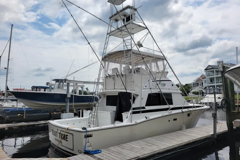 Slide: The Image of 1979 Bertram 38 Convertible yacht docked at marina under cloudy sky. - 8