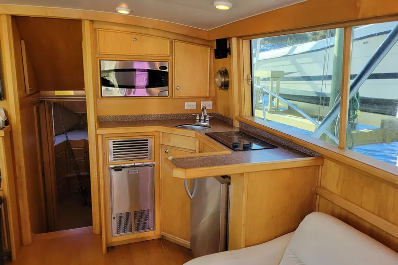 Slide: The Image of Interior of a 1979 Bertram 38 Convertible yacht with kitchen and seating area. - 9