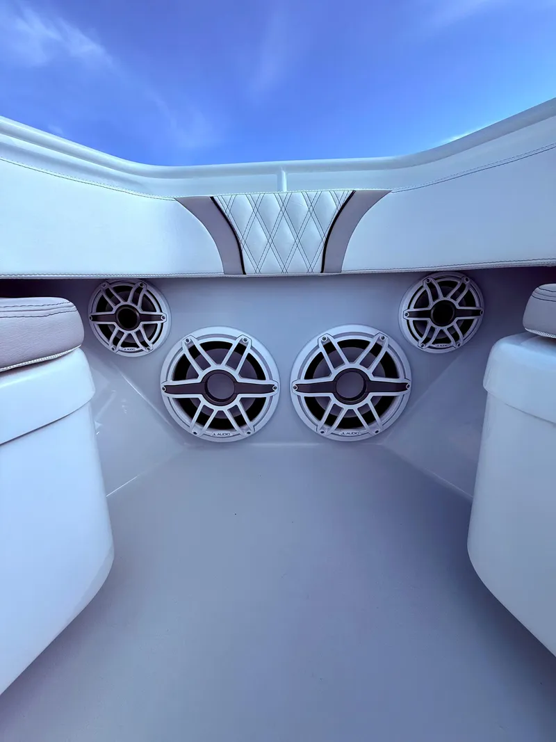 Slide: The Image of 2024 Contender 39 ST boat interior with premium speakers and cushioned seating. - 14