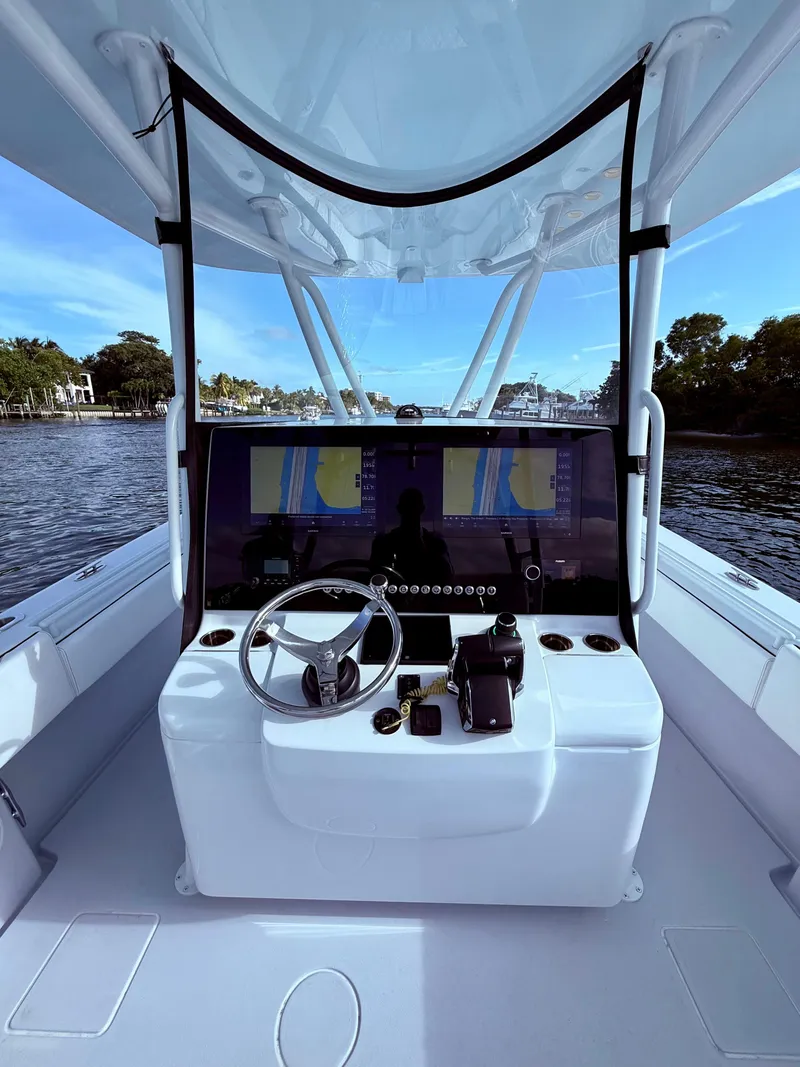 Slide: The Image of 2024 Contender 39 ST boat cockpit with advanced navigation system and steering wheel. - 22