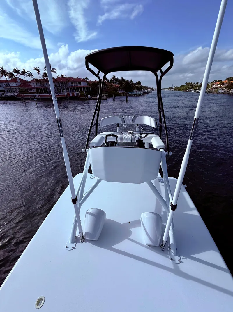 Slide: The Image of 2024 Contender 39 ST boat on calm water with scenic background. - 27