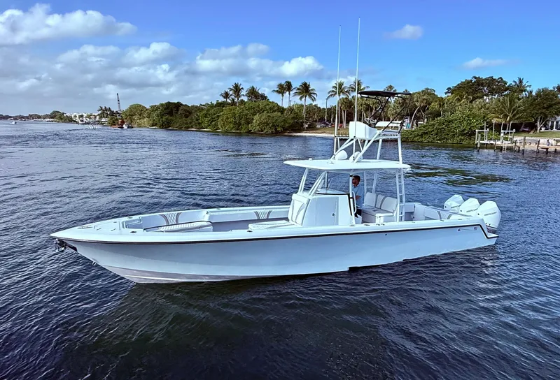Slide: The Image of 2024 Contender 39 ST boat on calm water with scenic background. - 3