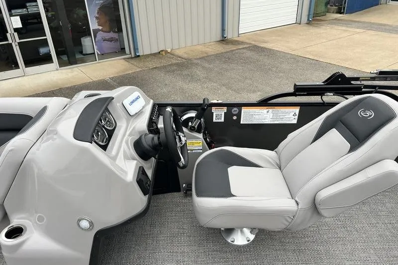 Slide: The Image of 2025 Barletta Aria 24UC boat interior with steering console and captain's chair. - 10