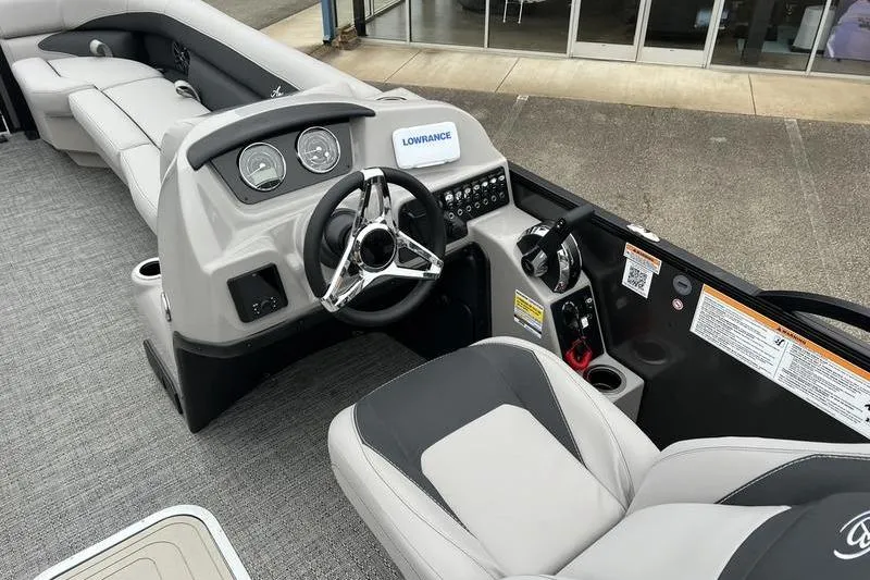 Slide: The Image of 2025 Barletta Aria 24UC boat interior with steering wheel and dashboard controls. - 11