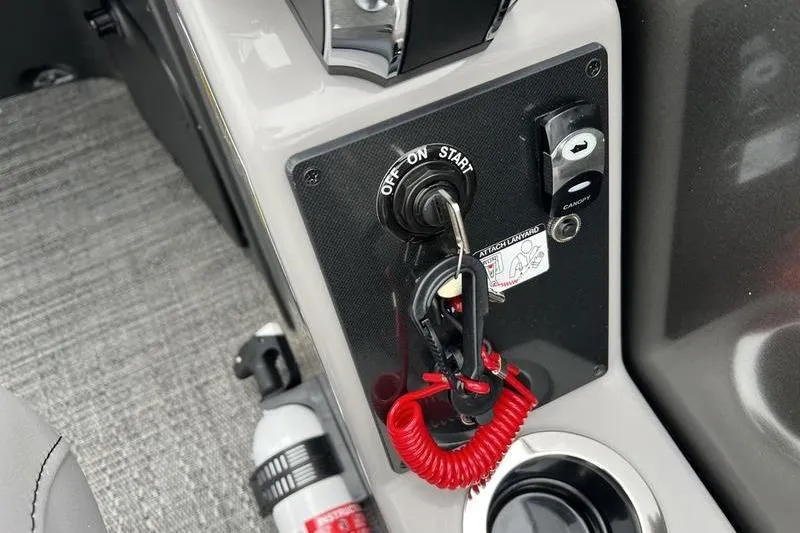 Slide: The Image of Control panel of 2025 Barletta Aria 24UC boat with ignition switch and safety features. - 16