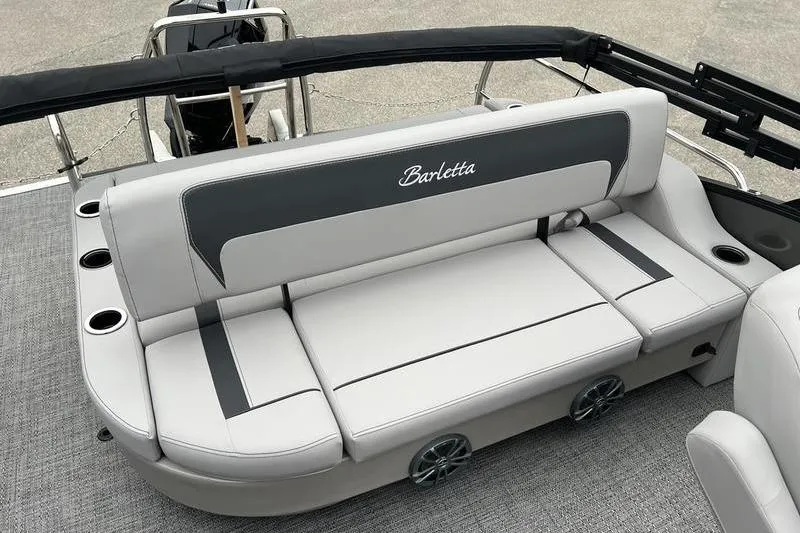 Slide: The Image of 2025 Barletta Aria 24UC boat interior with gray seating and cup holders. - 18