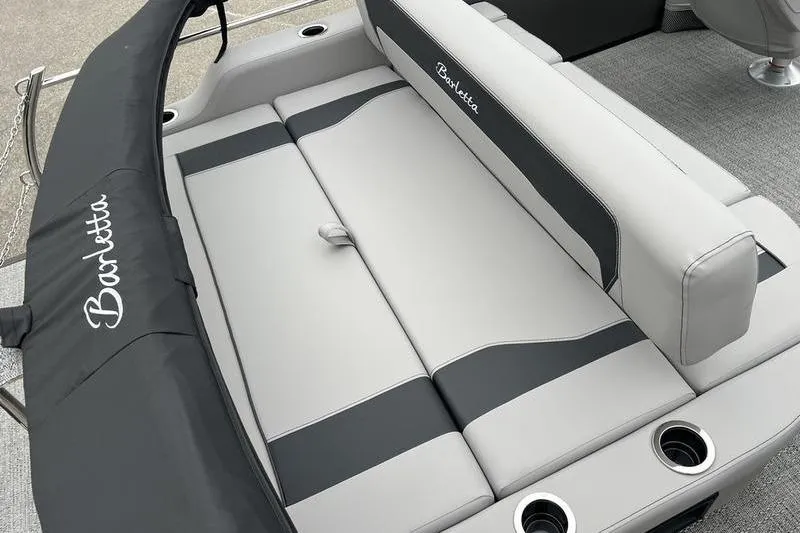 Slide: The Image of 2025 Barletta Aria 24UC boat interior with sleek gray seating and cup holders. - 19