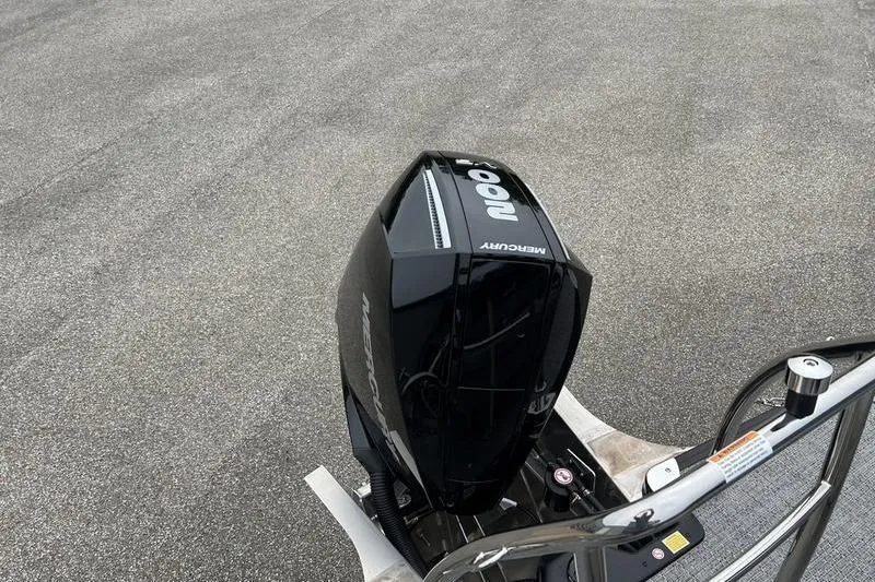 Slide: The Image of 2025 Barletta Aria 24UC with Mercury outboard motor on a paved surface. - 6