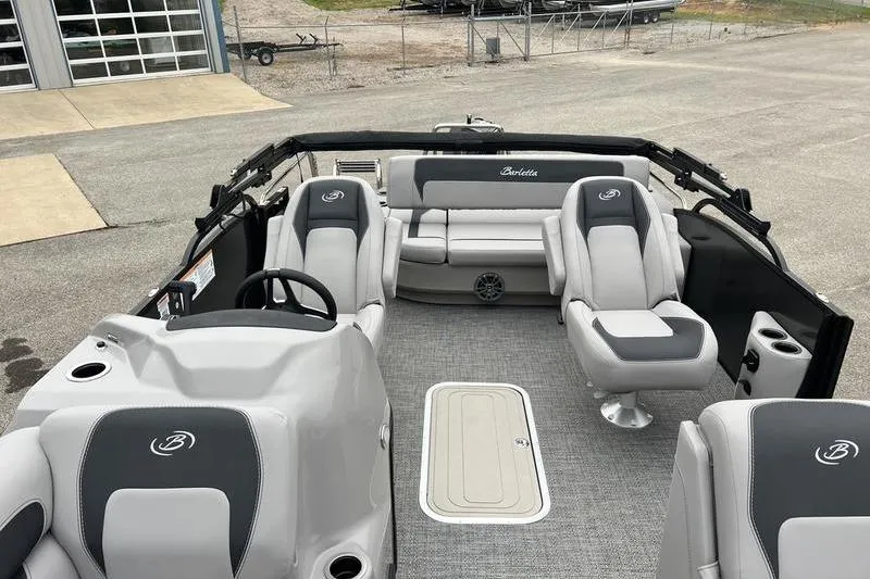 Slide: The Image of 2025 Barletta Aria 24UC pontoon boat interior with gray seating and modern design. - 8