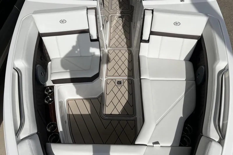 Slide: The Image of 2025 Cobalt R8 boat interior with white seating and patterned flooring. - 11