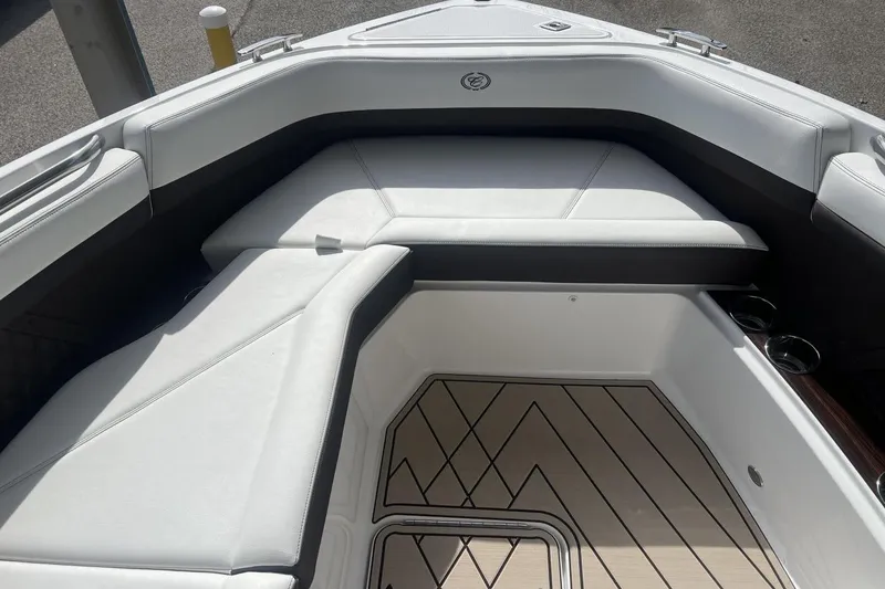 Slide: The Image of 2025 Cobalt R8 boat interior with white cushioned seating and patterned flooring. - 12
