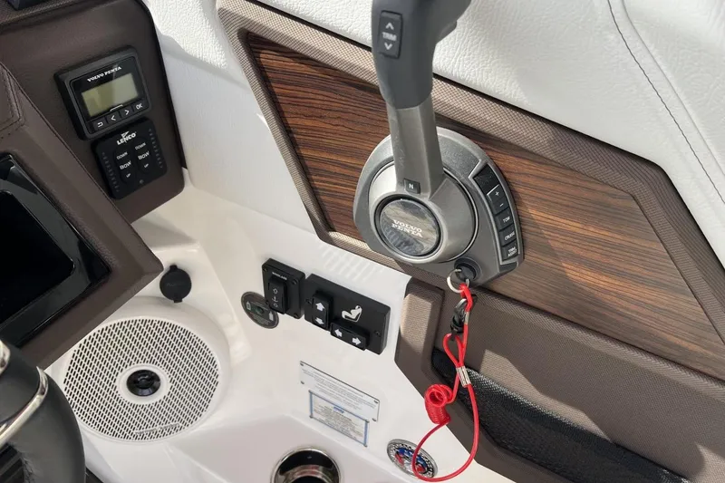 Slide: The Image of 2025 Cobalt R8 boat dashboard with controls, wood paneling, and speaker. - 7