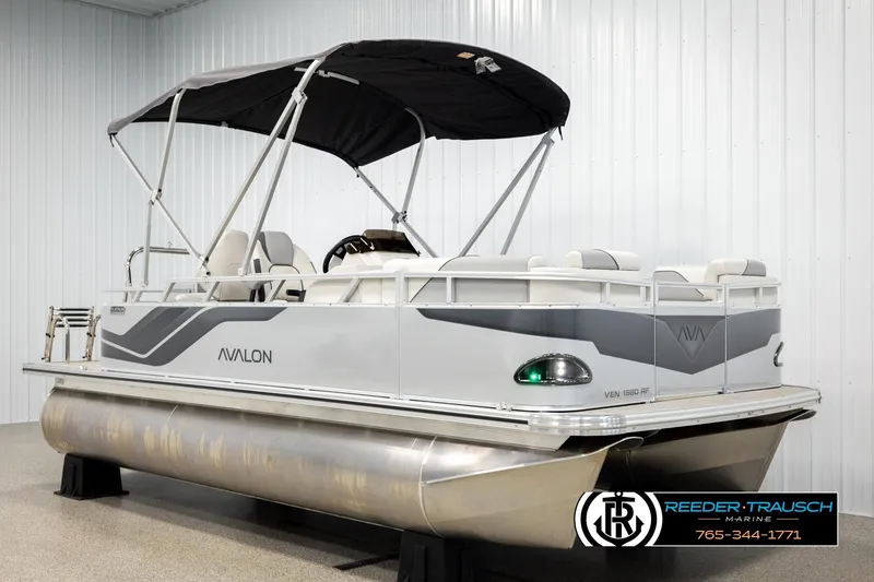 Slide: The Image of 2026 Avalon VEN RF pontoon boat with canopy, displayed indoors at Reeder-Trausch Marine. - 3