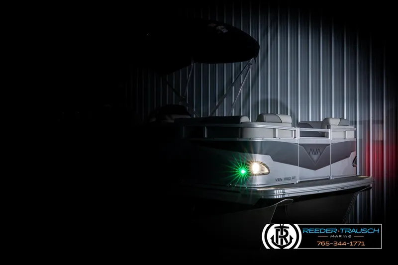 Slide: The Image of 2026 Avalon VEN RF pontoon boat with illuminated navigation light in a dimly lit setting. - 4