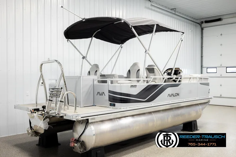 Slide: The Image of 2026 Avalon VEN RF pontoon boat in showroom, featuring sleek design and canopy. - 6