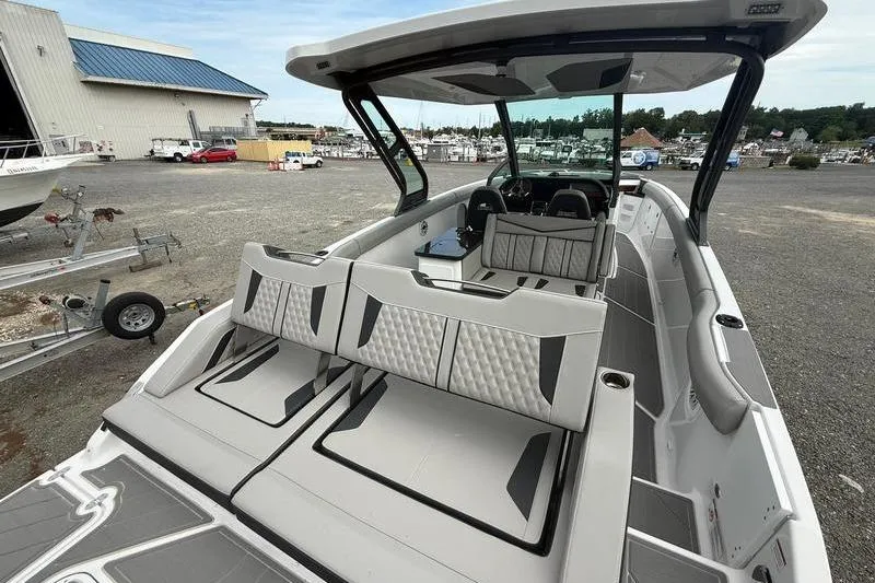 Slide: The Image of 2026 Monterey Elite 30 OB boat with sleek interior design at a marina. - 10