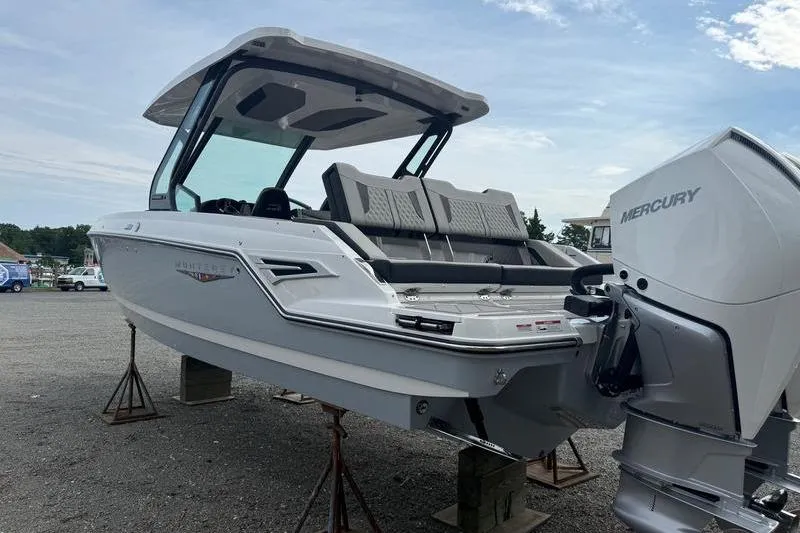 Slide: The Image of 2026 Monterey Elite 30 OB boat with Mercury outboard engine on display. - 3