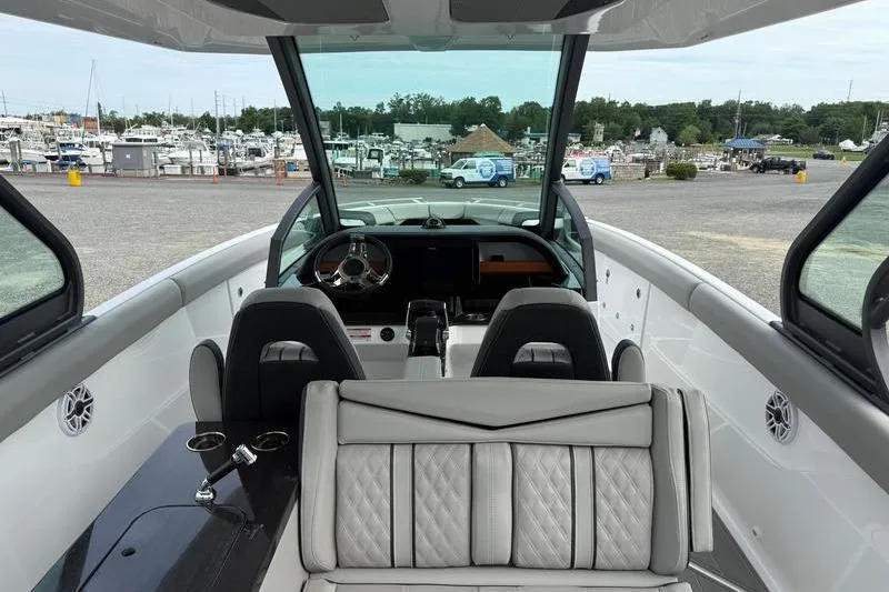 Slide: The Image of 2026 Monterey Elite 30 OB boat interior with luxurious seating and modern dashboard. - 7