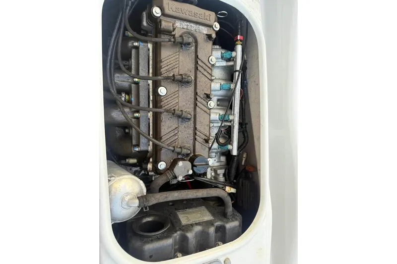 Slide: The Image of 2013 Kawasaki STX150 engine compartment, showcasing internal components and wiring. - 3