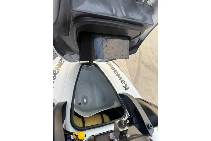 Slide: The Image of Open storage compartment of a 2013 Kawasaki STX150 jet ski, showing interior details. - 6