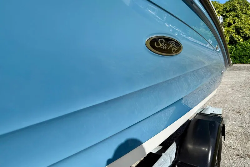 Slide: The Image of 2023 Searay SPX 190 boat in light blue on a trailer, showcasing sleek design. - 7