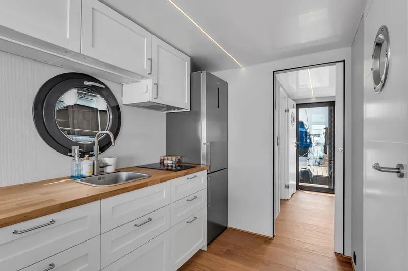 Slide: The Image of Modern kitchen interior of 2026 Waterlodge Apart L Long houseboat with sleek design. - 11