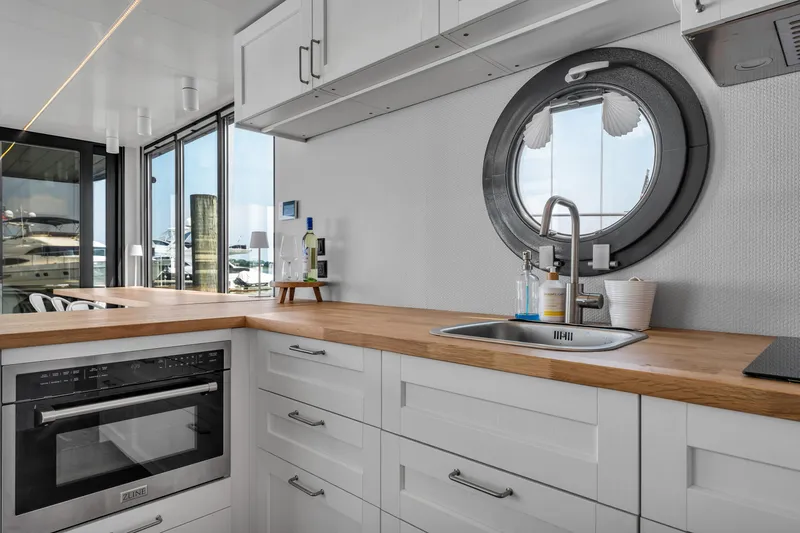 Slide: The Image of Modern kitchen in 2026 Waterlodge Apart L Long, featuring sleek design and porthole window. - 13