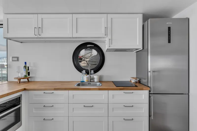 Slide: The Image of Modern kitchen in Waterlodge Apart L Long 2026, featuring sleek cabinets and stainless steel appliances. - 14