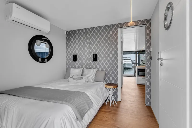 Slide: The Image of Modern bedroom in 2026 Waterlodge Apart L Long houseboat with stylish decor and waterfront view. - 17