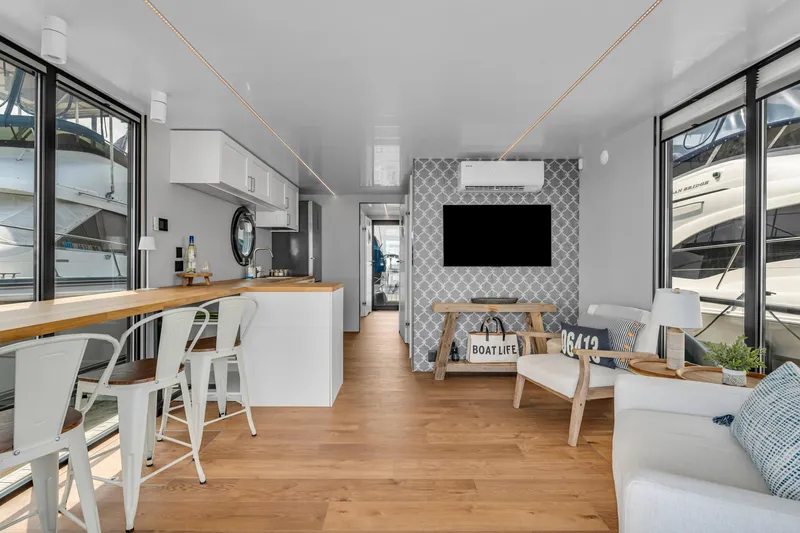 Slide: The Image of Modern Waterlodge Apart L Long 2026 interior with sleek design, wooden flooring, and large windows. - 2