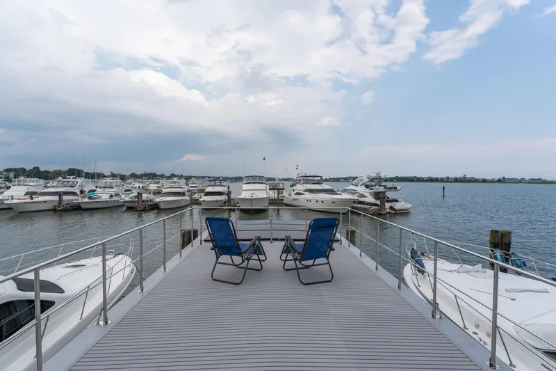 Slide: The Image of Deck view from Waterlodge Apart L Long 2026, overlooking marina with boats and blue sky. - 25