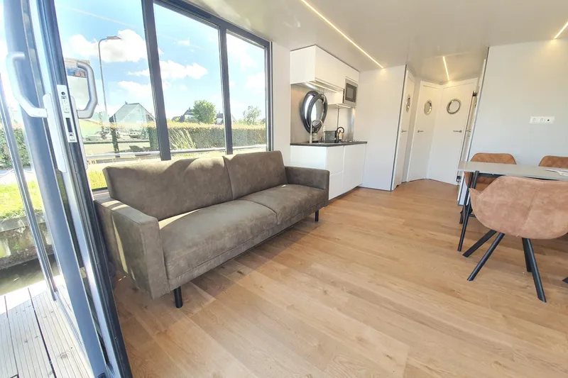 Slide: The Image of Modern Waterlodge Apart L Long 2026 interior with sofa, kitchenette, and dining area. - 30