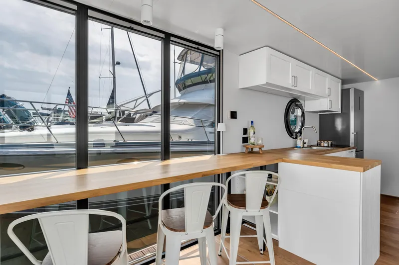 Slide: The Image of Modern Waterlodge Apart L Long 2026 interior with sleek kitchen and marina view. - 5