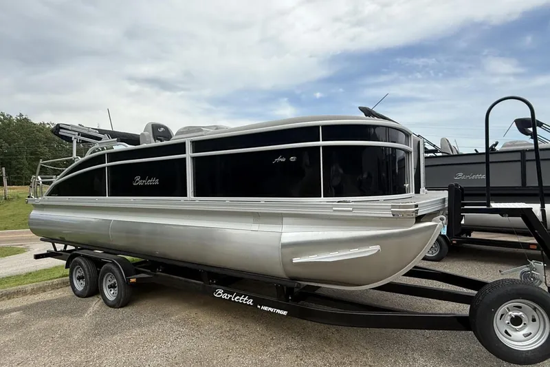 Slide: The Image of 2025 Barletta ARIA 22UC pontoon boat on trailer, sleek design, black and silver finish. - 8