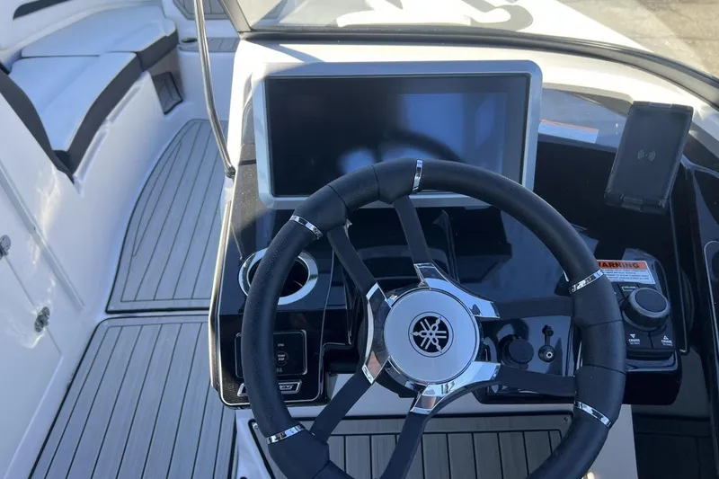 Slide: The Image of 2025 Yamaha Boats 252SE dashboard with steering wheel and touchscreen display. - 13