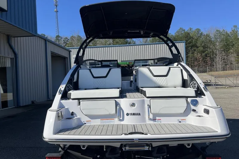 Slide: The Image of 2025 Yamaha Boats 252SE, rear view, showcasing sleek design and spacious seating. - 3