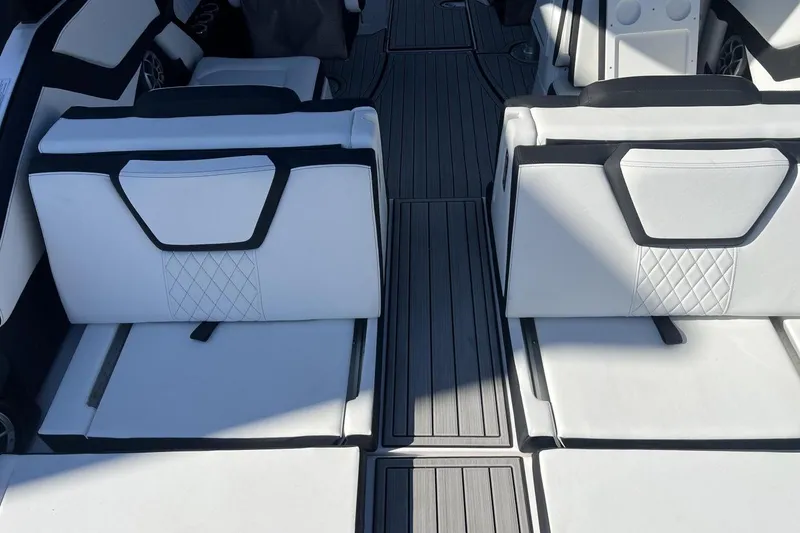 Slide: The Image of 2025 Yamaha Boats 252SE interior with white cushioned seating and sleek design. - 5