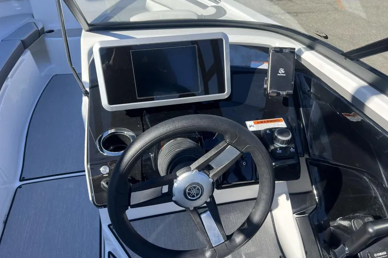 Slide: The Image of 2025 Yamaha Boats AR250 dashboard with steering wheel and touchscreen display. - 17