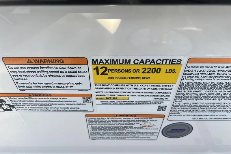 Slide: The Image of 2025 Yamaha Boats AR250 capacity label, warning of 12 persons or 2200 lbs maximum. - 19