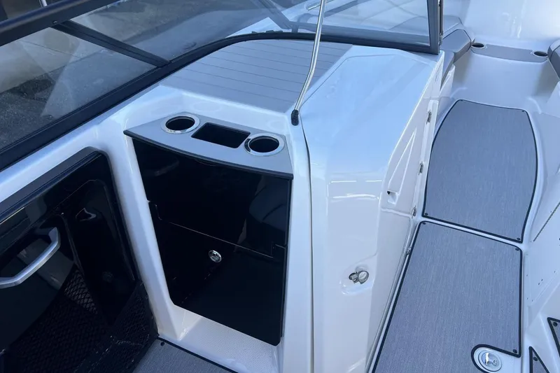 Slide: The Image of 2025 Yamaha Boats AR250 interior with cup holders and sleek design. - 21