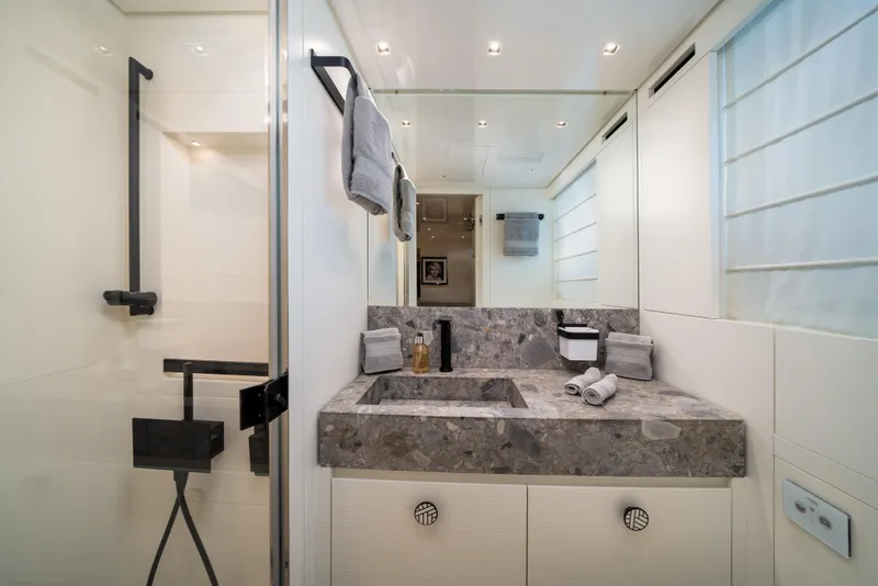 Slide: The Image of Luxurious bathroom in 2022 Sanlorenzo SL96A yacht with modern fixtures and elegant stone countertop. - 25