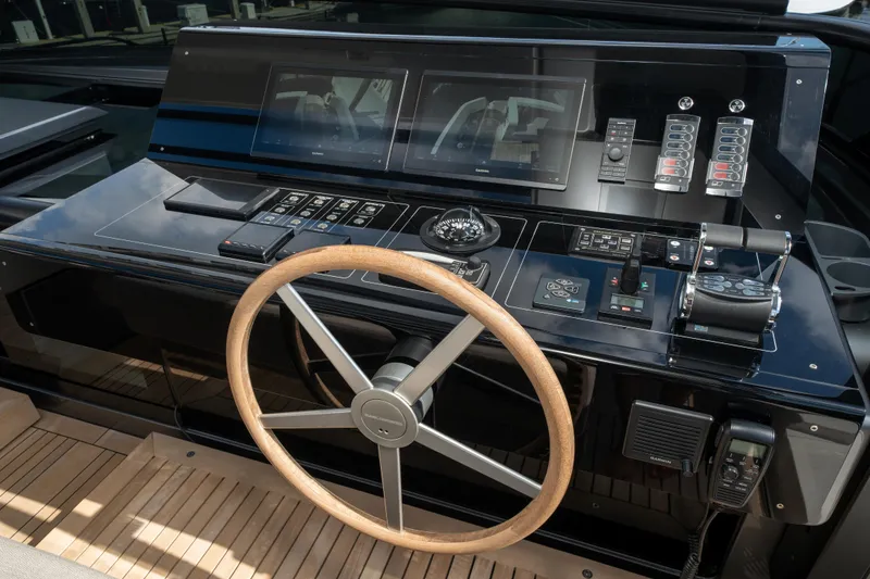 Slide: The Image of 2022 Sanlorenzo SL96A yacht helm with modern controls and wooden steering wheel. - 3