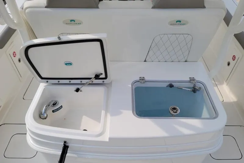 Slide: The Image of 2021 World Cat 325 CC boat dashboard with Garmin and Simrad navigation systems. - 14
