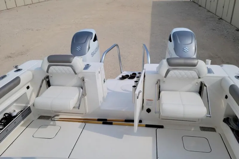 Slide: The Image of Twin propellers of a 2021 World Cat 325 CC boat on sandy ground. - 4