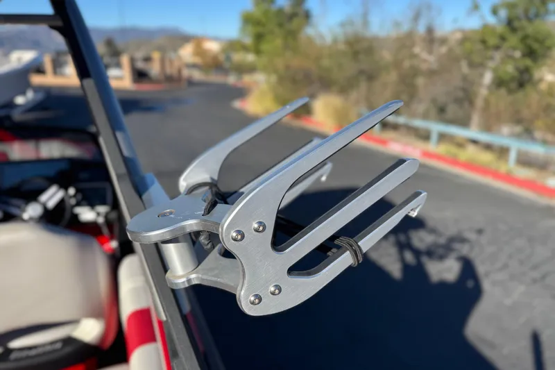 Slide: The Image of 2018 Malibu Wakesetter 21 MLX wakeboard rack in a sunny outdoor setting. - 11